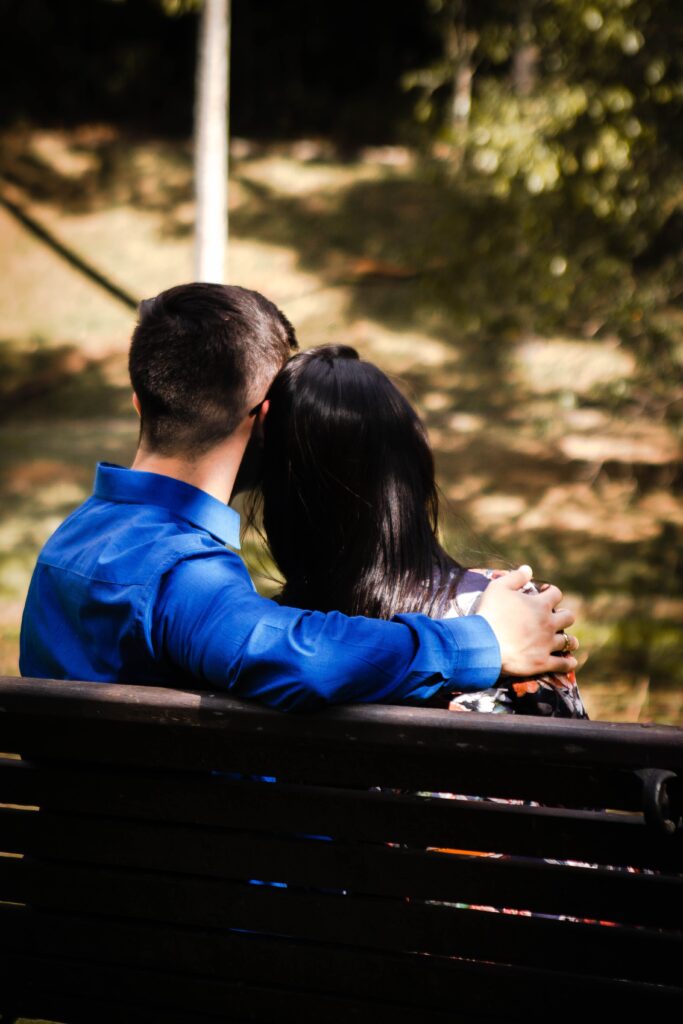 A loving couple embracing on a park bench in São Paulo, Brazil.